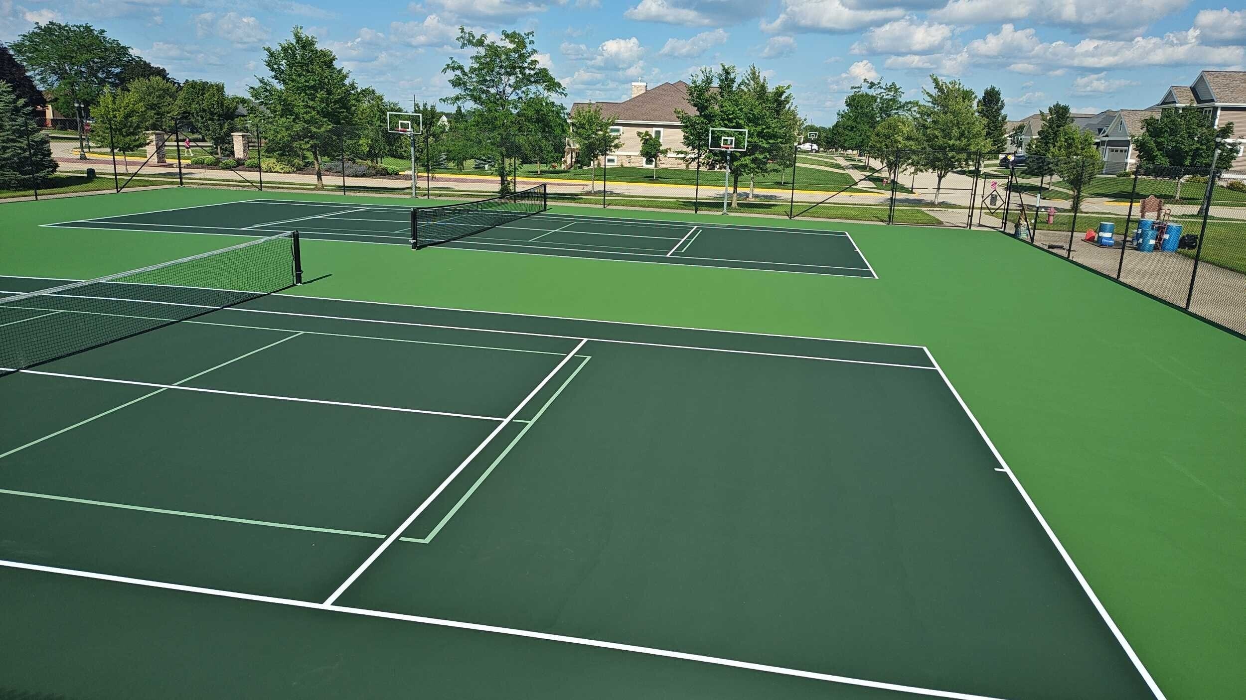 Newly resurfaced tennis court with clean lines and smooth surface.
