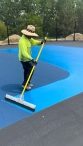Crew working on a court resurfacing project