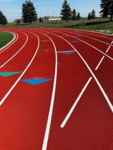 Newly resurfaced red running track with white lane markings in Harrisburg.