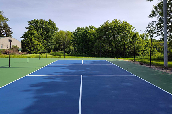 Transformed tennis courts at Campbell Park into four vibrant pickleball courts with crack repairs and fresh acrylic surfacing by Pro Track and Tennis.