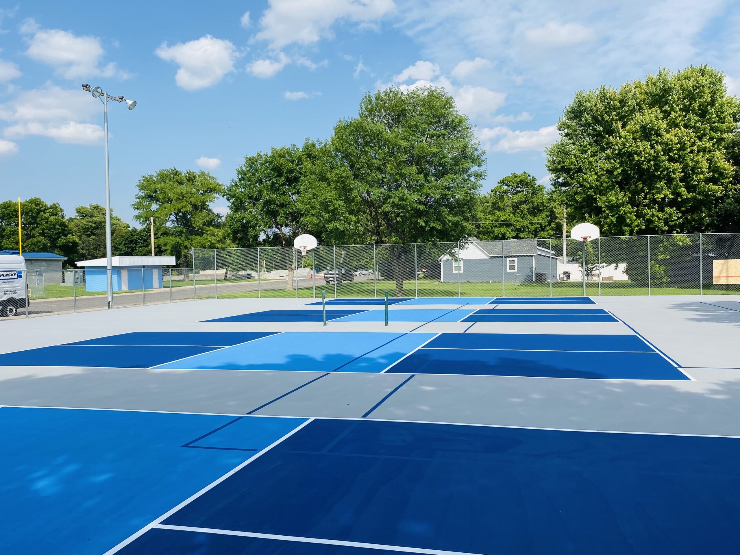 Dual-purpose court configured for both tennis and pickleball use