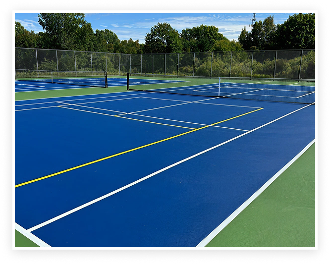 Newly resurfaced outdoor tennis courts with blue and green acrylic surface, fresh white and yellow line striping