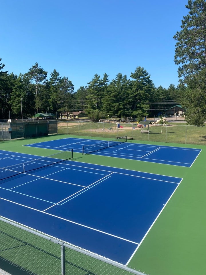 Resurfaced tennis court with professional finish and fresh paint