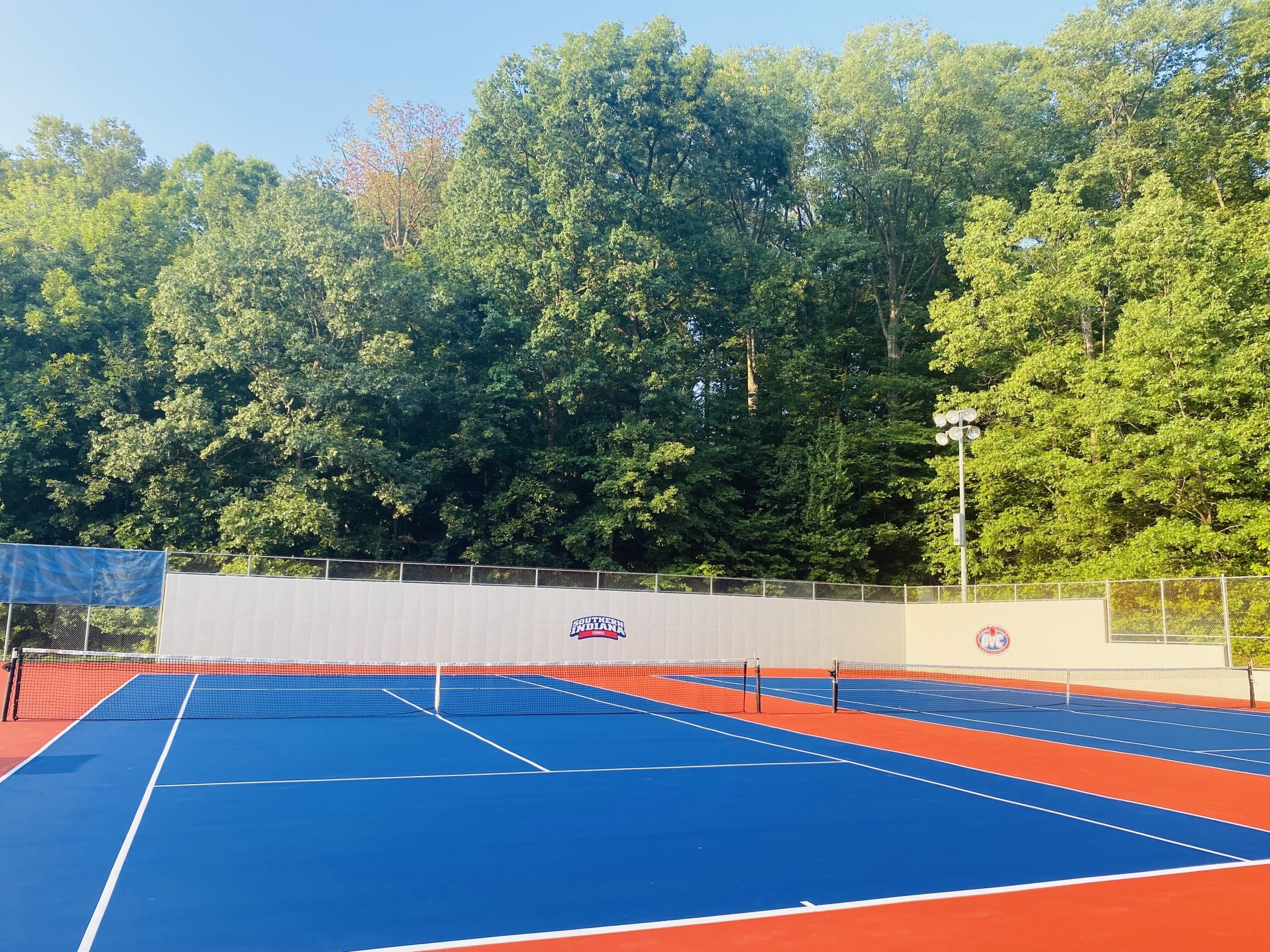 Newly resurfaced tennis court with vibrant and custom finish