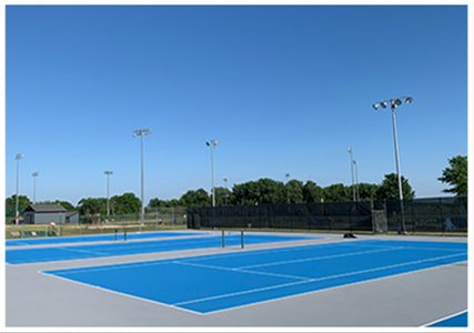 Outdoor blue and gray tennis courts resurfaced with Novacrylic premium acrylic materials