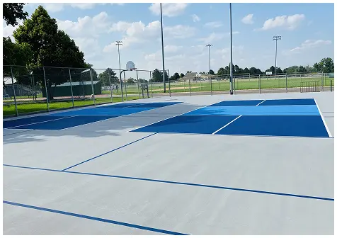 Resurfaced pickleball courts with fresh blue acrylic coating, white lines, and slip-resistant finish