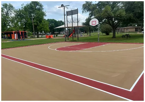 Red and tan outdoor basketball and multi-use court with UV-resistant acrylic surface coating