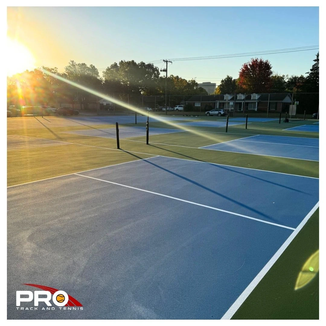 2 Newly resurfaced outdoor courts at a Tulsa city park, featuring blue-and-green playing surfaces, updated line markings, and improved accessibility.