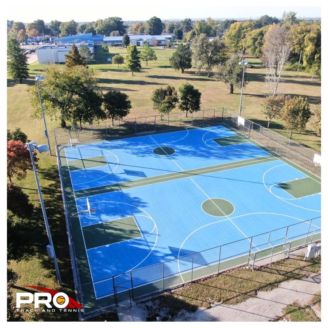 Tulsa Case Study - Square “Overhead view of a completed multi-court outdoor sports surface with fresh blue-and-green coatings and clear game lines.