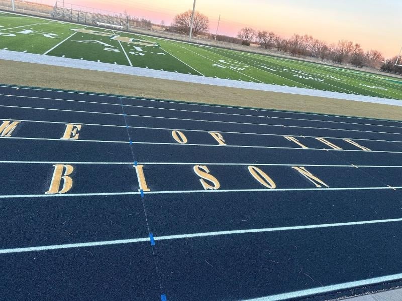 High school running track lanes with start markings, showing a standard 400-meter school track used for competition and resurfacing.