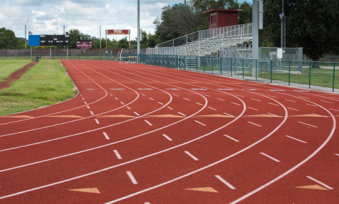 Mondo Track Recently resurfaced red running track with clearly marked lanes at a school athletic facility