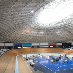 Indoor track with banked curves designed for high speed competition in a modern sports arena