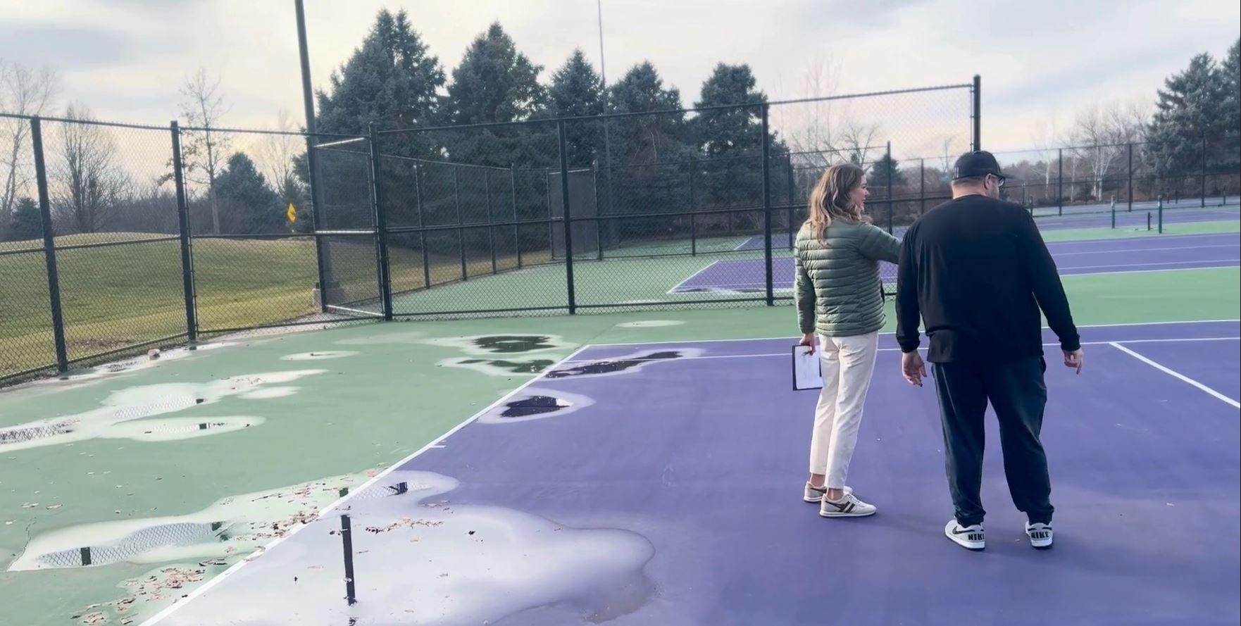 Tennis court inspection showing standing water and surface issues to guide resurfacing decisions