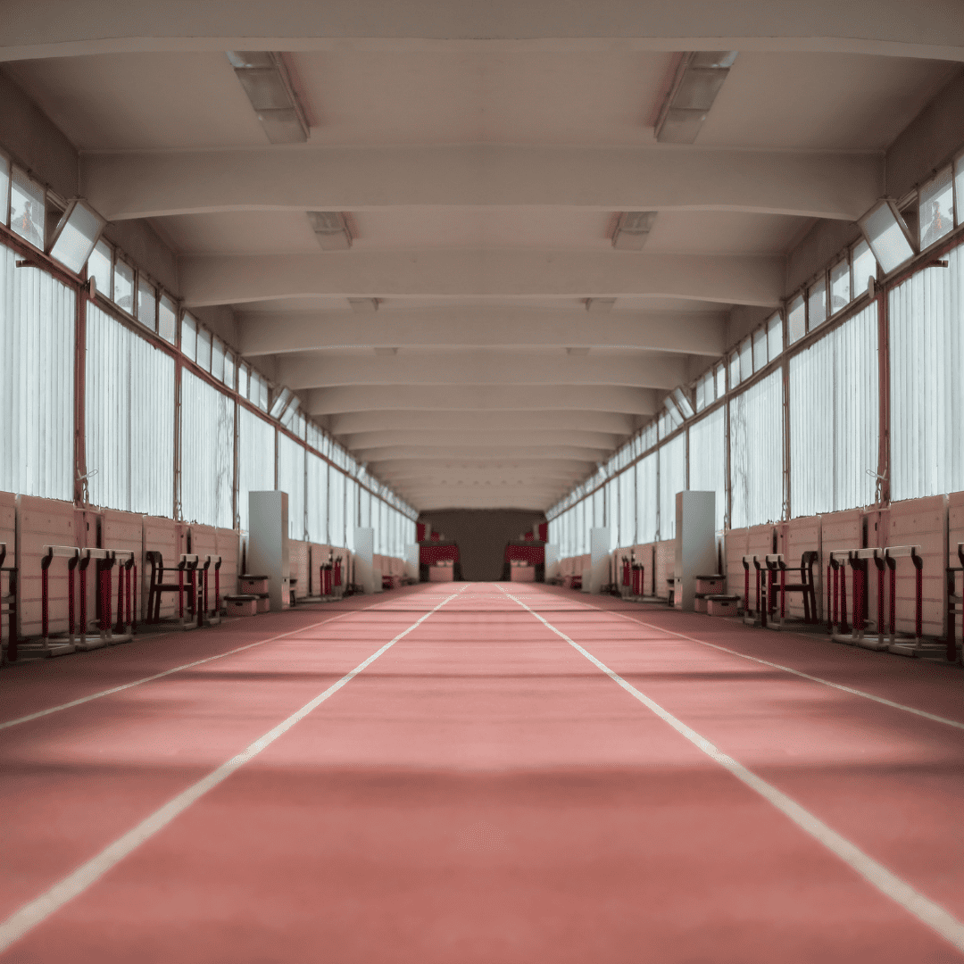 Indoor running track inside a training facility showing straightaway lanes used for indoor track events