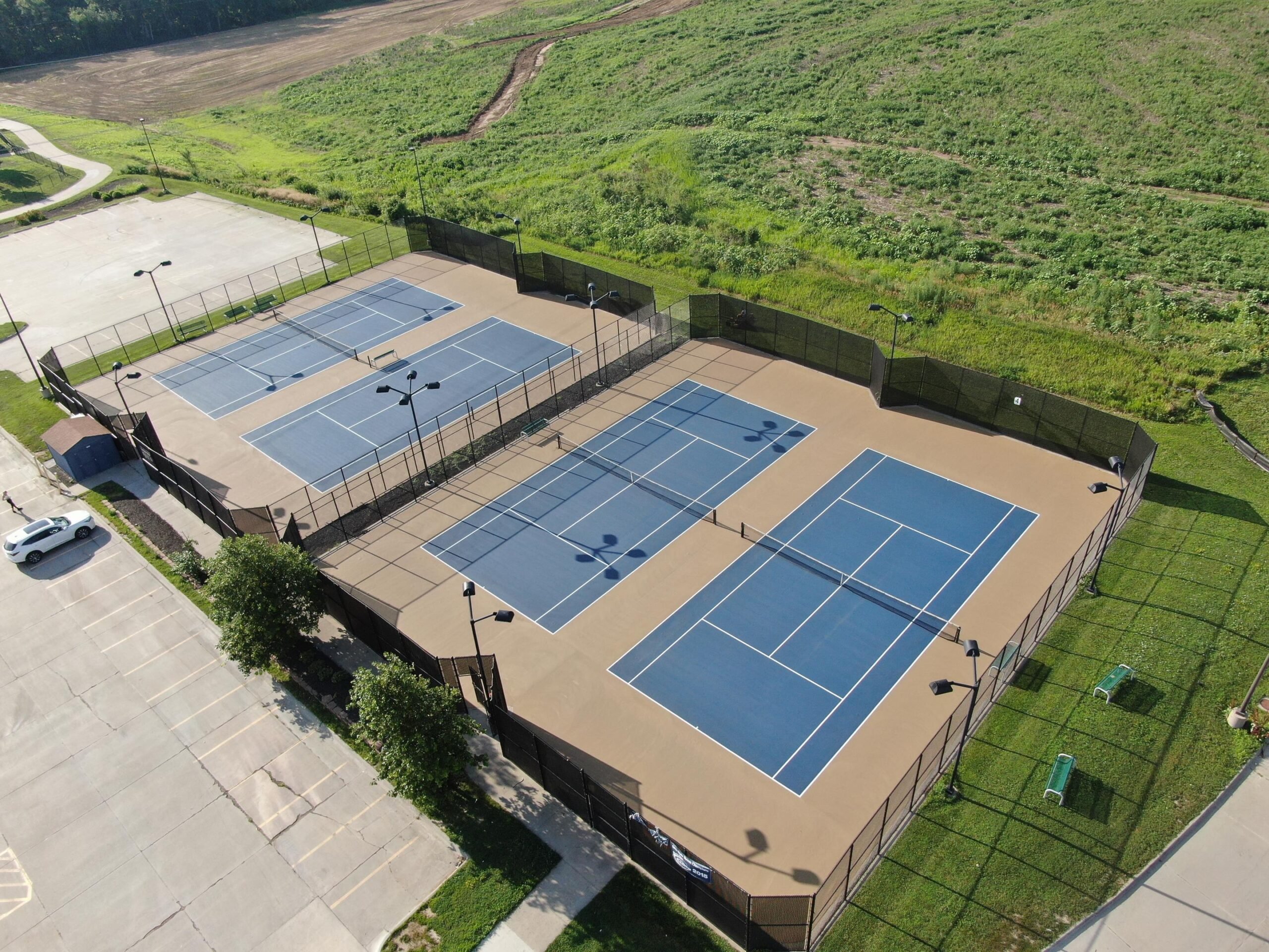 Aerial view of school tennis courts resurfaced for student athletes and school facility upgrades