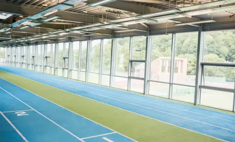 Indoor running track Indoor running track with marked lanes inside a modern sports facility showing standard indoor track design