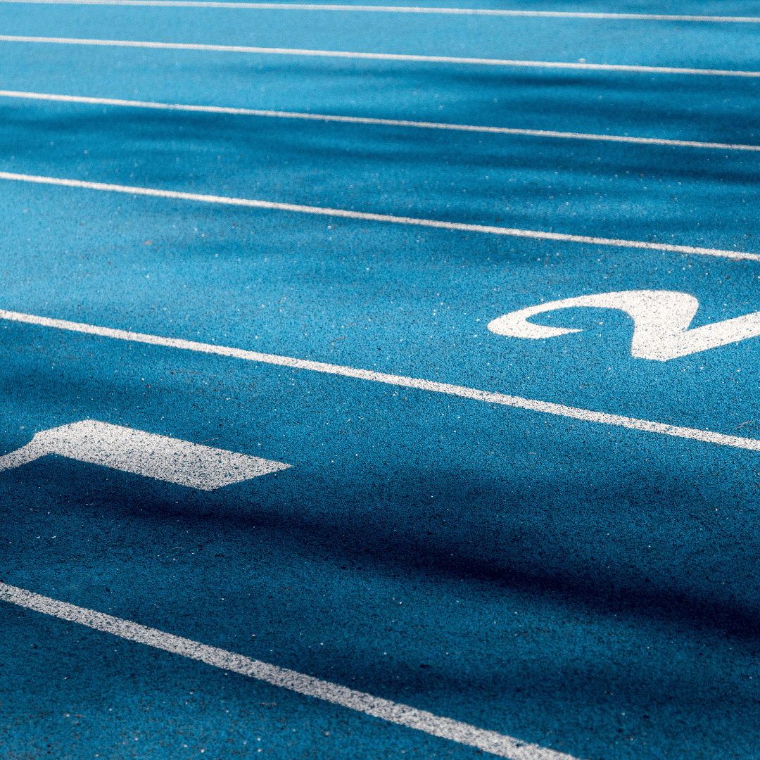 Indoor running track lanes with lane numbers painted on a synthetic track surface
