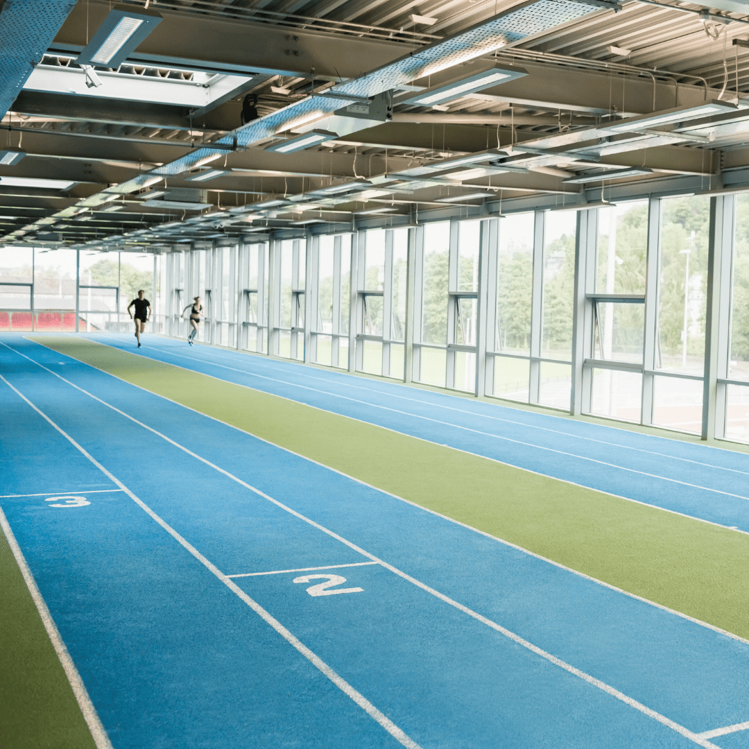 ndoor running track with marked lanes showing standard indoor track design inside a sports facility