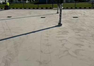 Bare concrete pickleball court surface before resurfacing at a residential community in Baytown, Texas