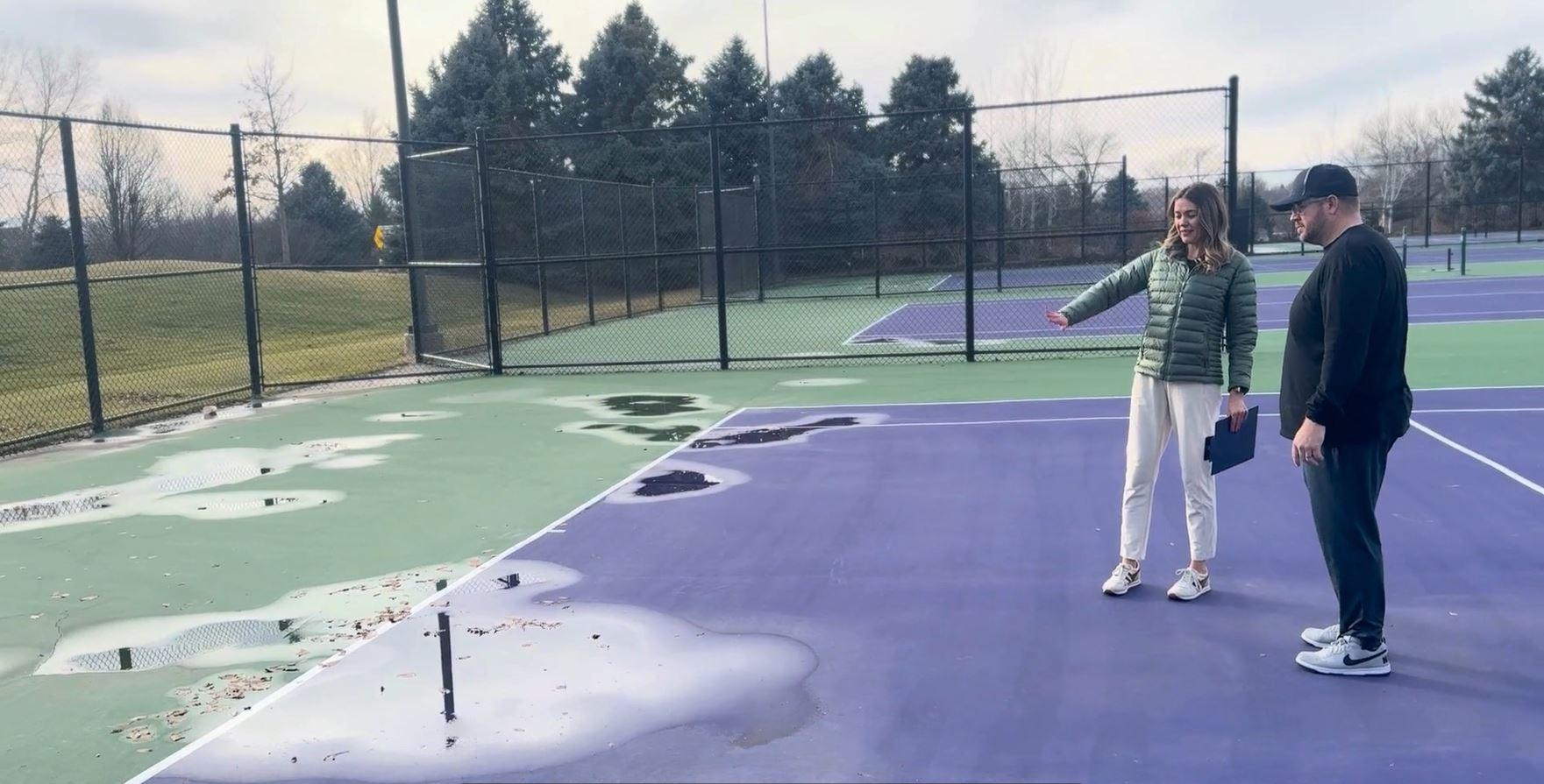 Tennis court inspection showing surface damage and water pooling that can impact efforts to extend tennis court lifespan