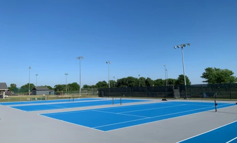 Renovated Country Club Tennis Courts Renovated blue tennis courts at a country club facility with fresh surfacing and line striping.