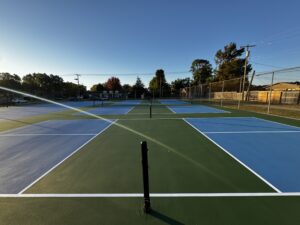 Country club tennis courts showing renovation planning and surface condition assessment for facility managers.