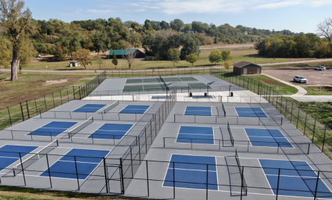 pickleball courts ready for typti play Aerial view of a multi-court pickleball facility with blue and gray surfacing