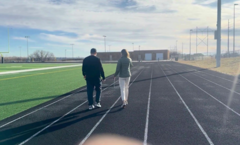 running-track-certification-surface-review Athletic facility staff walking a running track during a surface review for certification requirements.