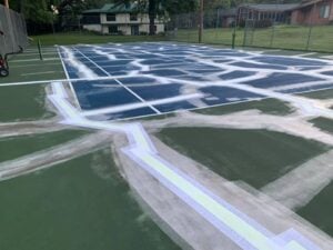 tennis court surface with extensive crack repair preparation before resurfacing